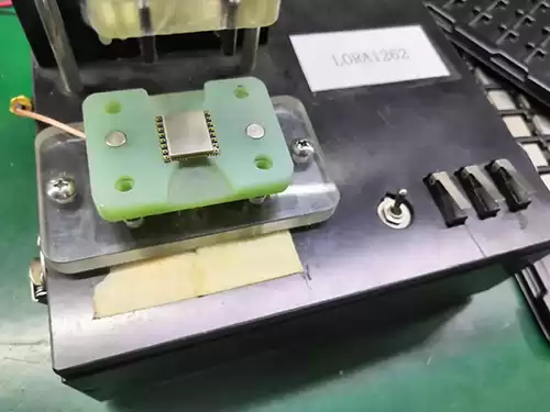 Put the LoRa module LoRa1262 into the fixture of the product function test stand in the correct direction